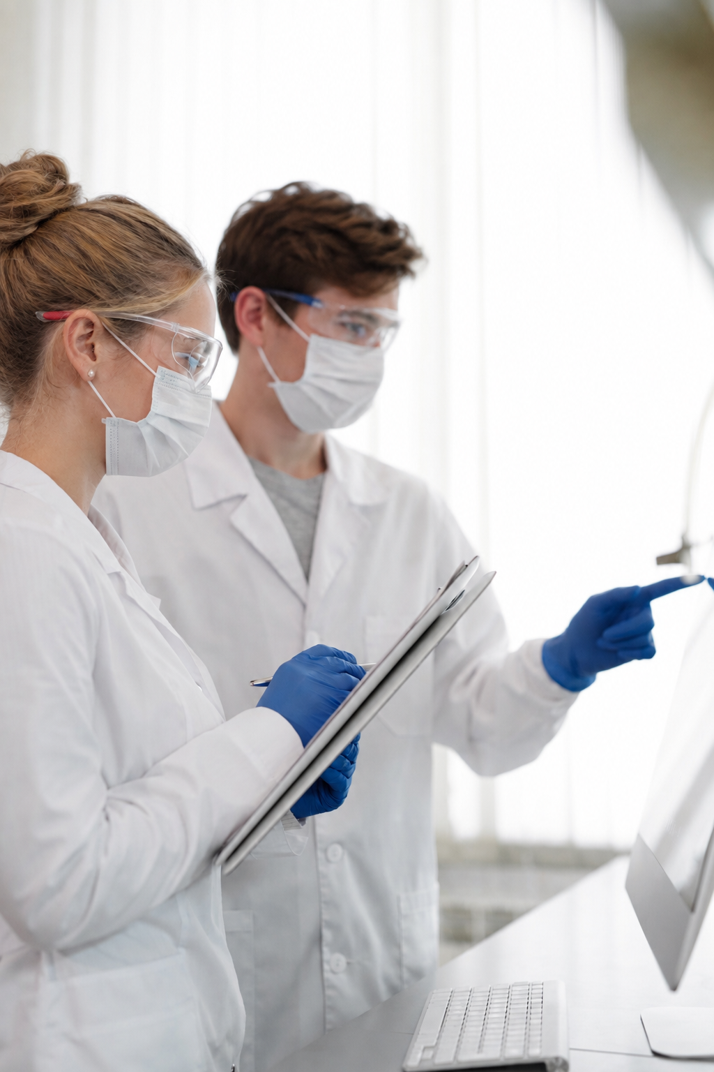 Researchers discussing their work in a laboratory